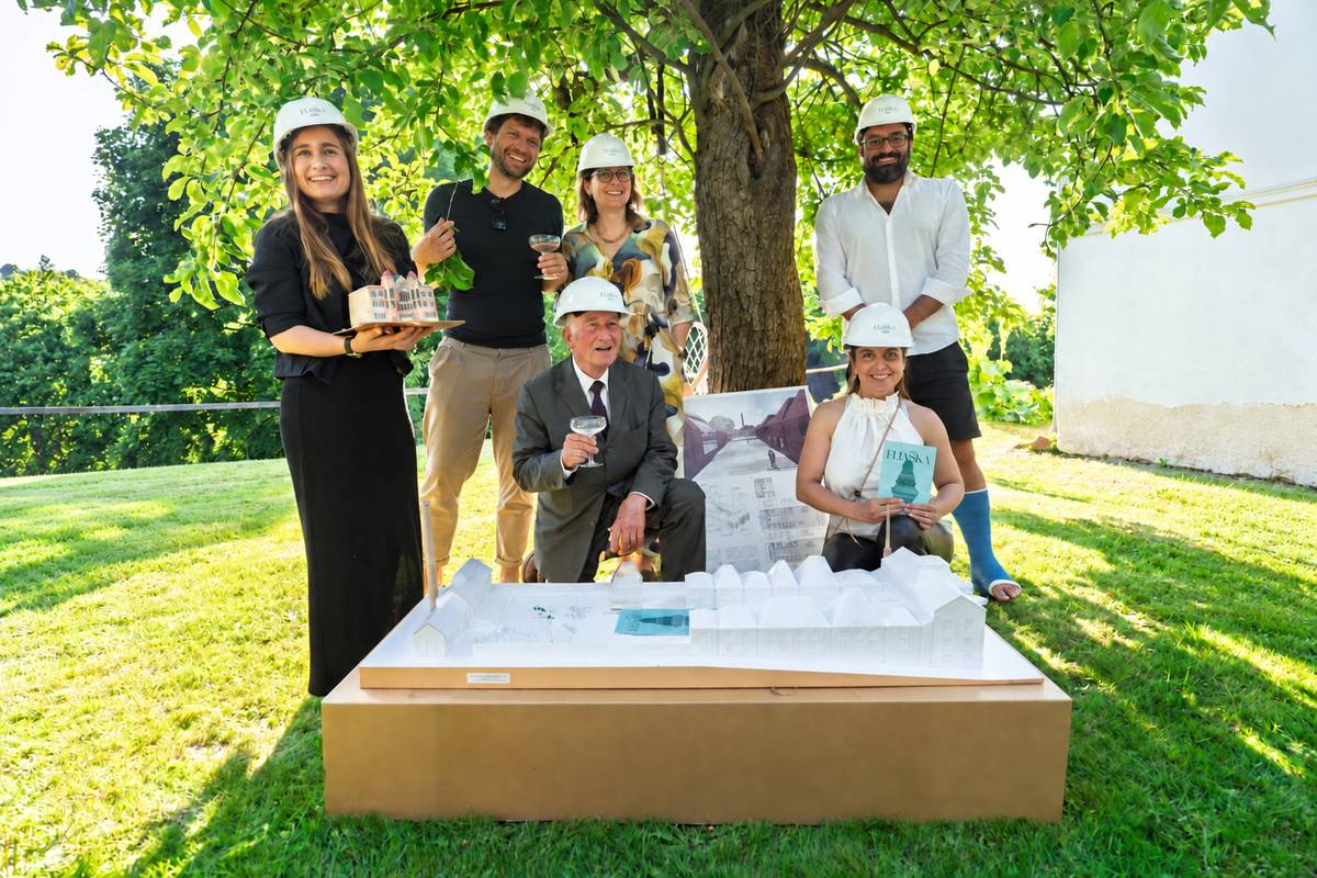 The Eliáška team with a model of the factory